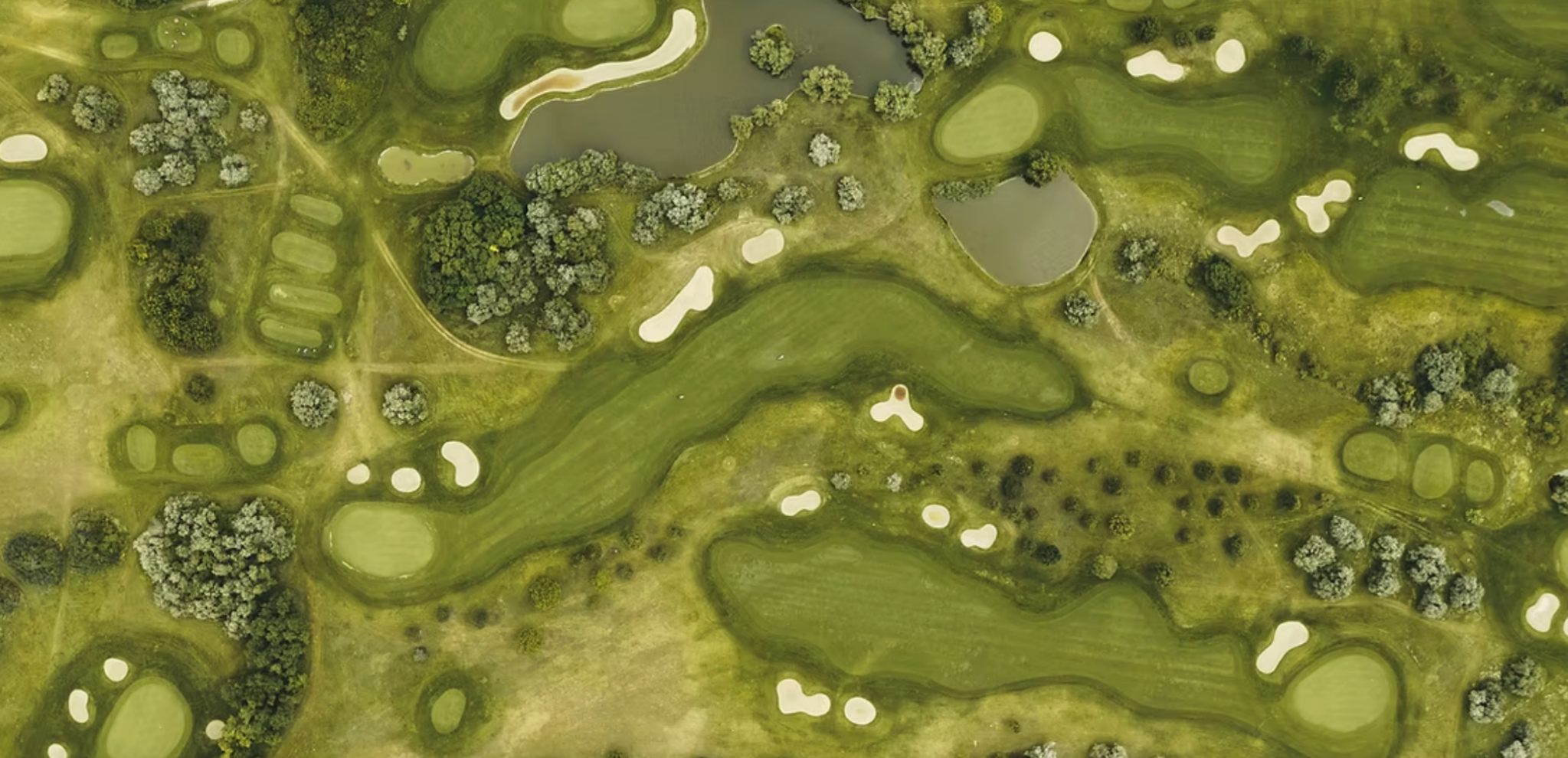 Large aerial view of golf course fairways and greens
